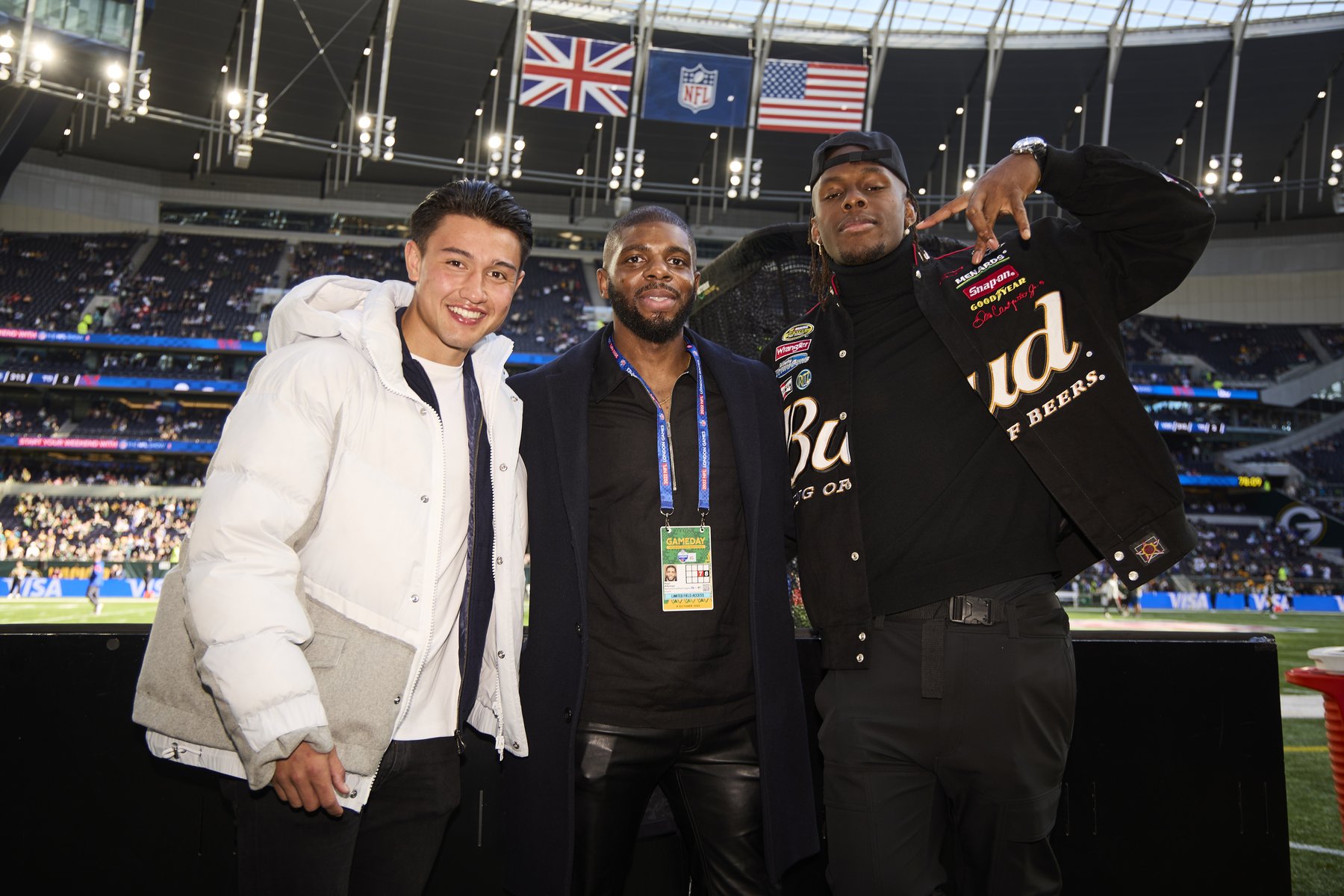 Client-supplied photograph of three people at a stadium